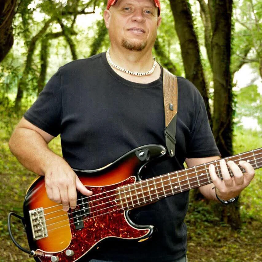 Lowell Jeffery playing his sunburst Precision Bass outdoors